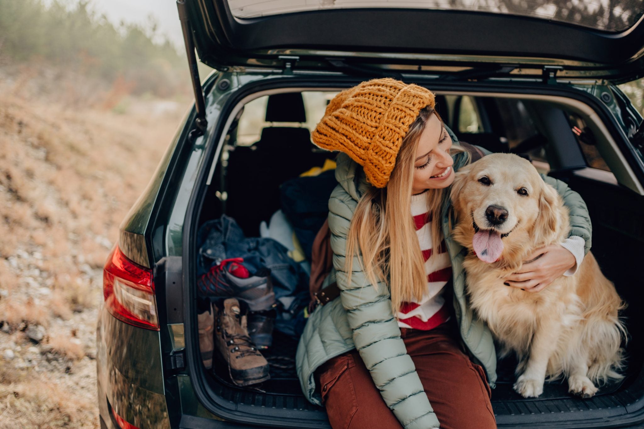 owner-with-dog-in-trunk-of-car