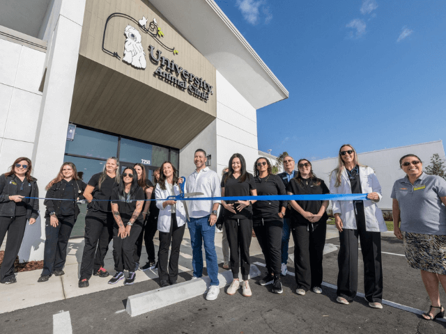 University team at the ribbon cutting of their new location